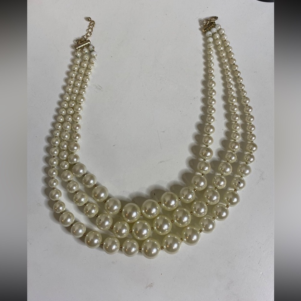 Triple strand pearl necklace may be Ralph Lauren